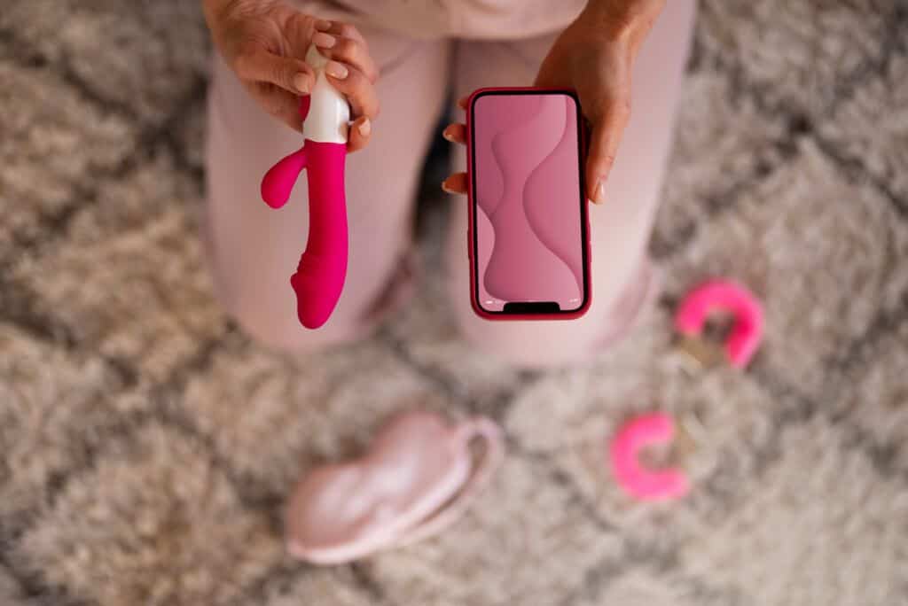 top view woman with smartphone vibrator 1