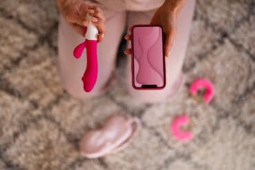 top view woman with smartphone vibrator 1